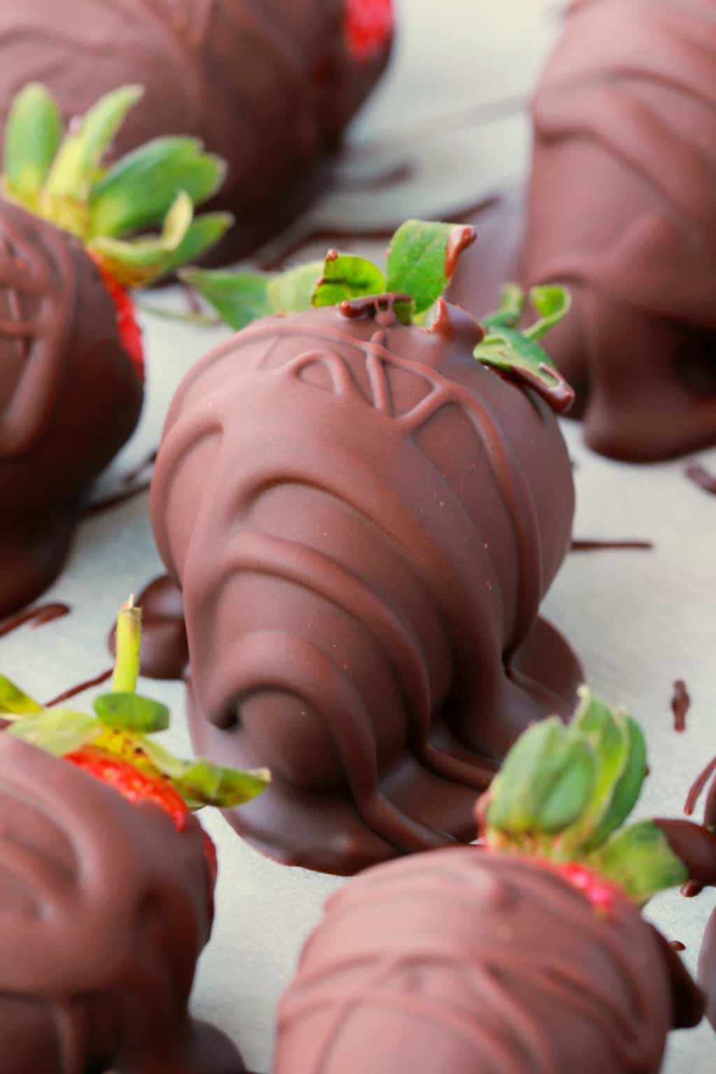 Fraises enrobées de chocolat végétalien sur papier parchemin