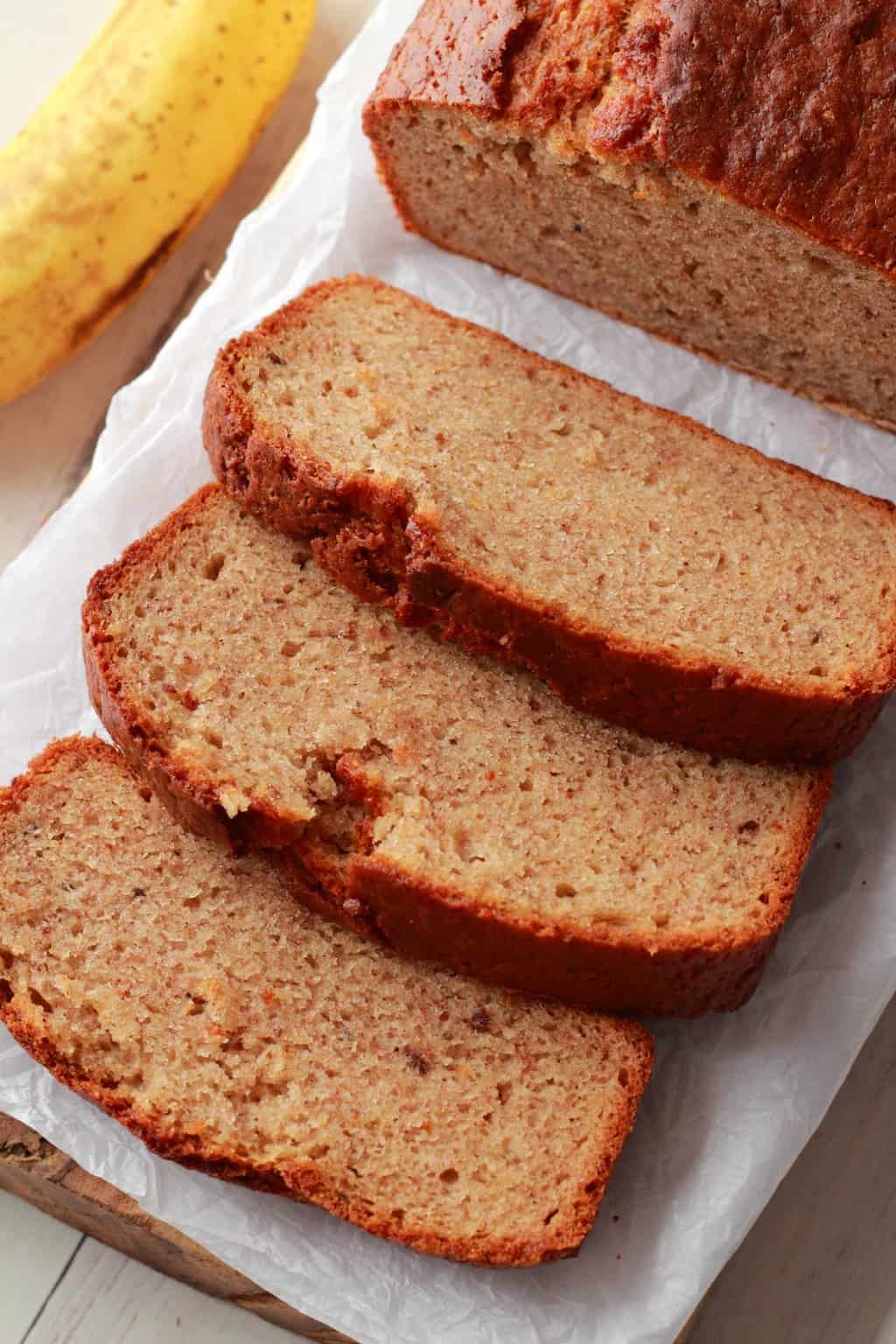 Pain aux bananes vegan tranché sur du papier sulfurisé.