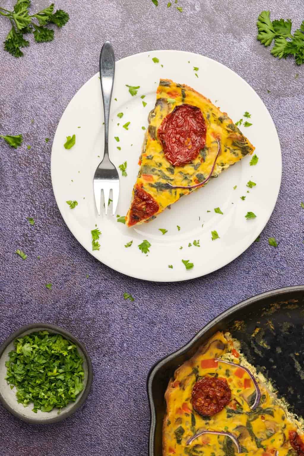 Tranche de frittata sur une plaque blanche.