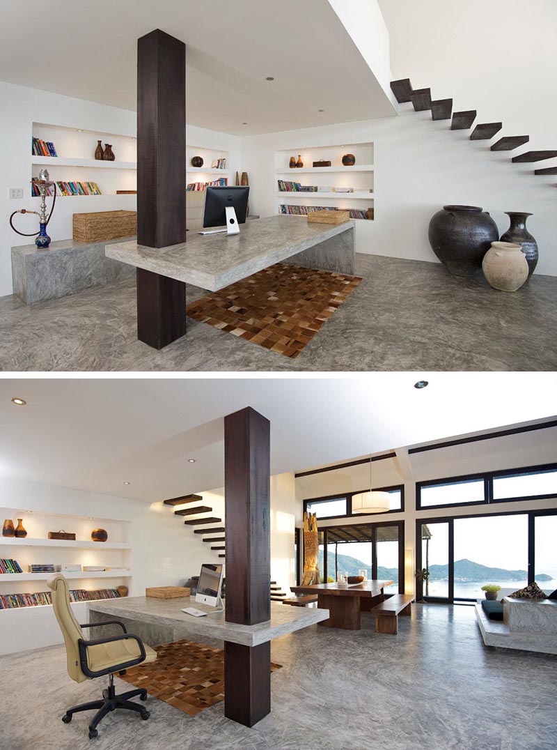 Dans un bureau à domicile moderne, un bureau en béton personnalisé a été conçu pour inclure une colonne en bois comme support.