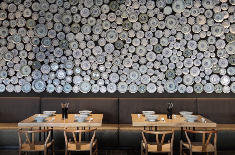 Un mur d'accent de restaurant fait d'assiettes et de bols.